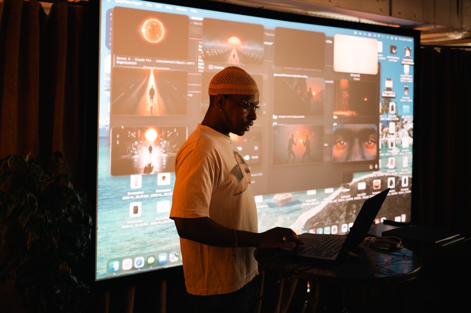 A member demonstrating AI generated visuals on the big screen