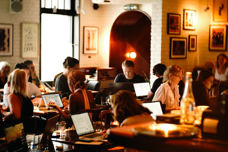 The room at a Light School AI day in London, with everyone building on laptops