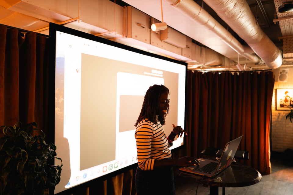 A member presenting the project they built to the rest of the room