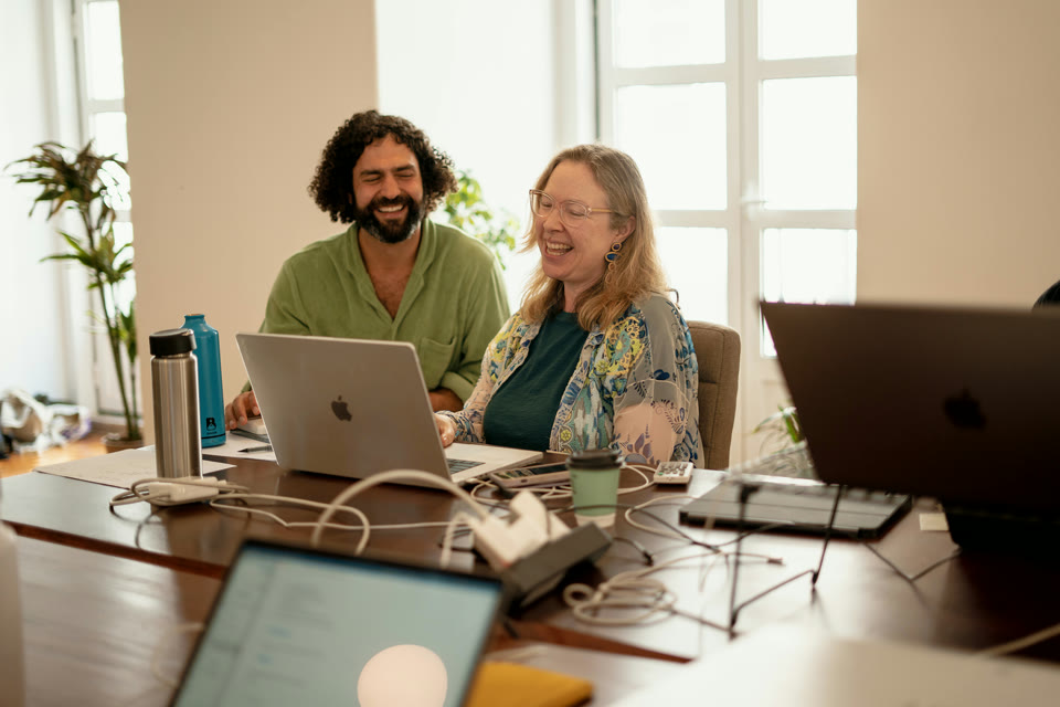 Nick Sarafa laughing with a member while they build together at Light School